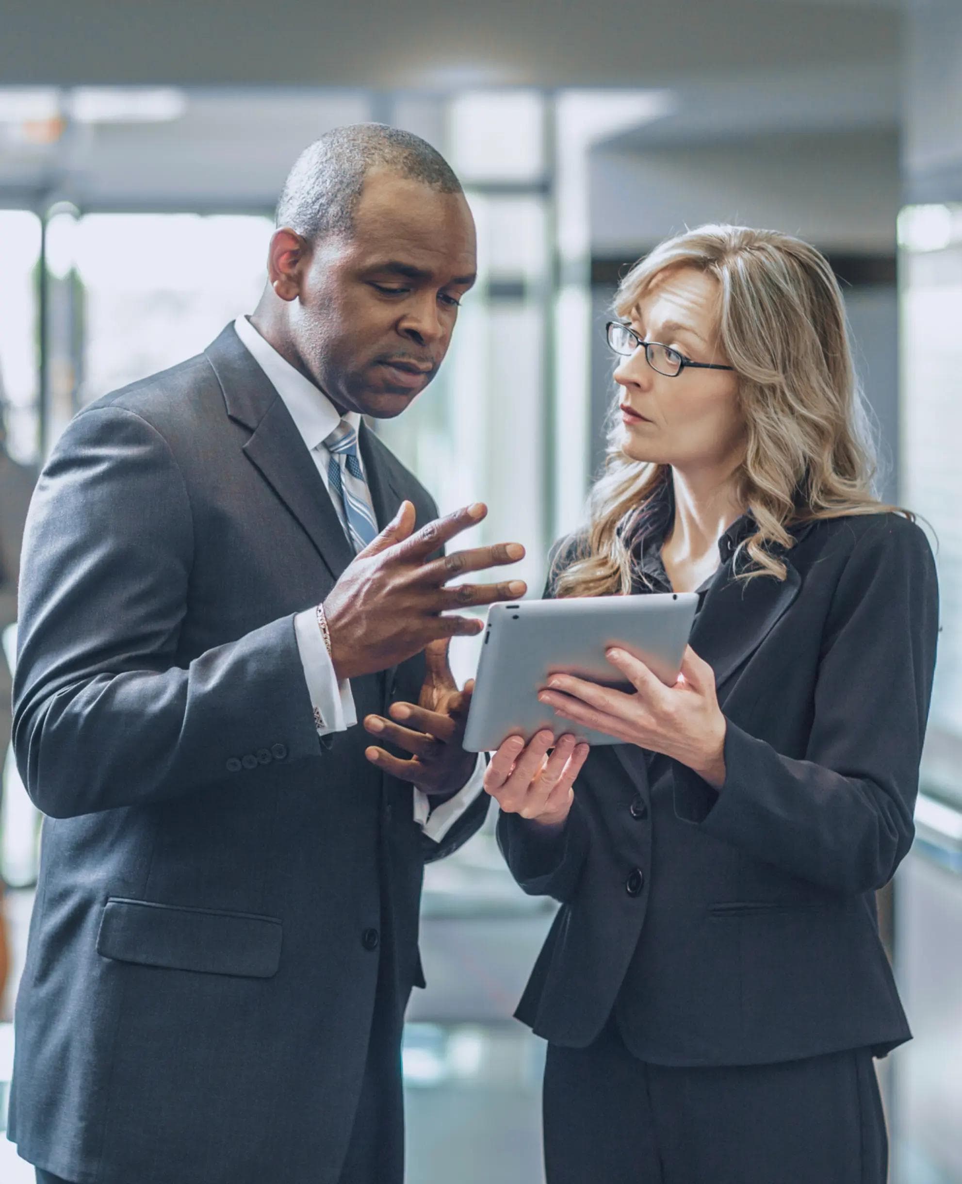 Image of two people reviewing an ipad.